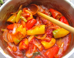 saute diced white onions, sliced scallions and garlic paste in olive oil, addcapsicum of your choice (bell peppers, chilis or combination thereof), add tomato paste, a bit of chicken stock, kosher salt and cayenne pepper, simmer for three minutes,, add fresh basil,  check / adjust seasoning